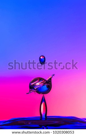 Water droplet collision on a blue and red background