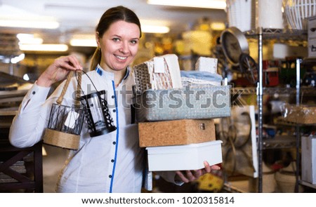 Young woman is demonstraiting modern home decoration in furniture shop