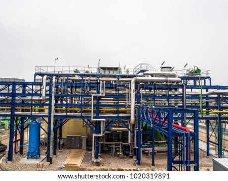 steam pipe line and blue pipe rack in power plant. Royalty-Free Stock Photo #1020319891