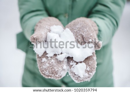 White snow on mittens close-up. Winter theme.