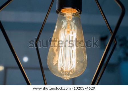 A glowing light bulb in a transparent room.