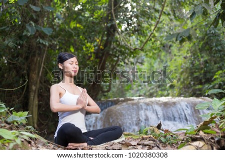 Young woman asia meditates while practicing yoga relax in nature 