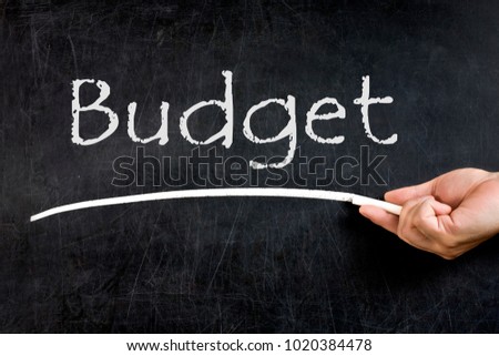 Budget handwritten and underlined on blackboard or chalkboard
