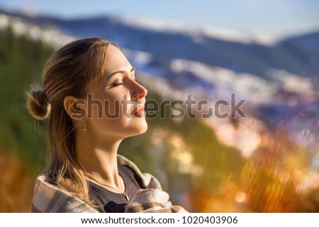 Autumn mountain portrait of the brunette girl in the plaid - closeup emotions beauty photo with flares.