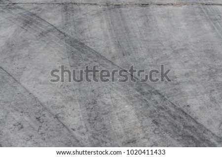 Abstract background black tire tracks on cement floor, Tire trace on the ground, tire marks on cement floor.