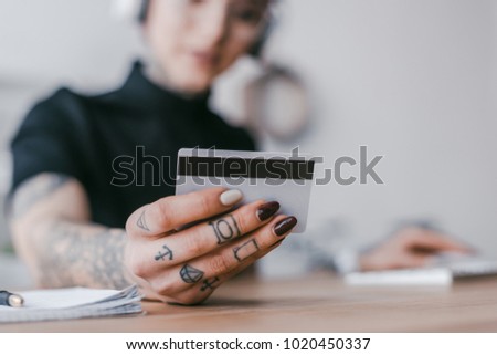 selective focus of young woman holding credit card