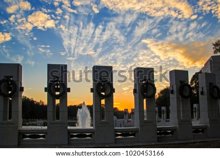 View of World War II Memorial against the beautiful sunset background in Washington DC USA. It commemorates Americans who served in the armed forces and as civilians during World War II