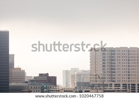 Cityscape scene with low hanging clouds taken in landscape orientation
