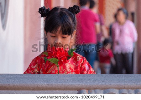 Chinese girl get gift on the day of the Chinese new year. Note : Chinese characters in the picture means good luck.