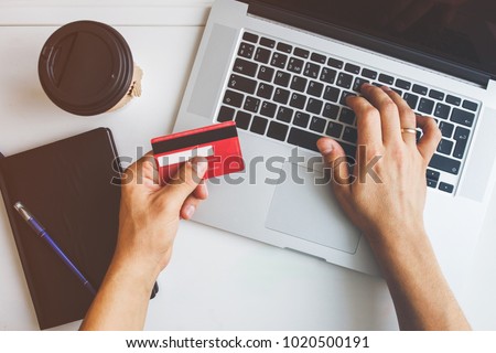 Top view of man using credit card for online shoping Royalty-Free Stock Photo #1020500191