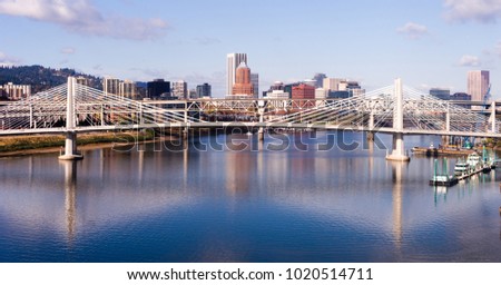 A pedestrian and transit bidge along with interstate 5  cross over the Willamette River in Portland