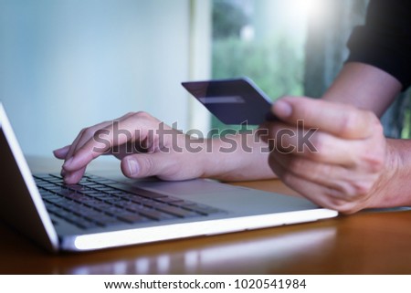 Man's hands holding credit card and typing on the keyboard of laptop, onine shopping, online payment. Royalty-Free Stock Photo #1020541984
