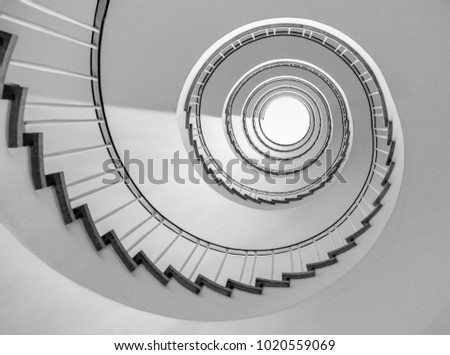 helical stairway, simple modern circular staircase, view from underneath in black and white