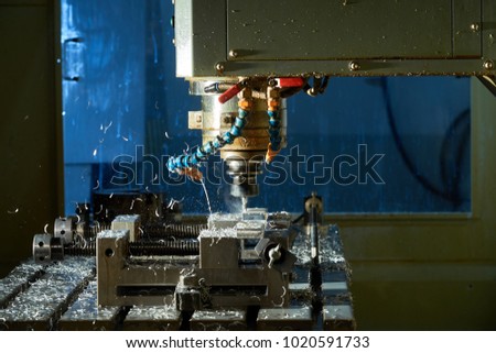 Metalworking CNC milling machine. Cutting metal modern processing technology.Milling metalworking process. Industrial high precision CNC metal machining by vertical mill.  