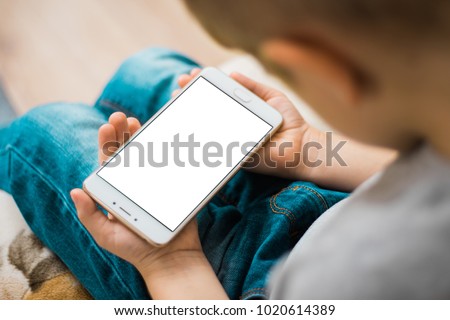 Little boy use mobile phone. White, blank, isolated screen White screen for mock up for mockup isolated