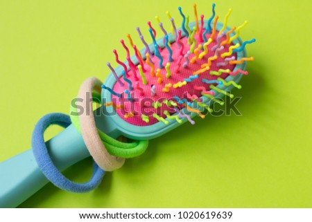 Colorfull hair brush and hair accessories for pastel backgrounds