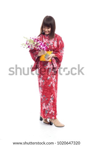 Charming southeast asian woman wearing kimono with orchid flowers on white background.