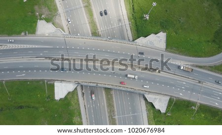 Elevated expressway. Clip. Top view at curves and lines of city highway. The curve of suspension bridge. Background scenic road