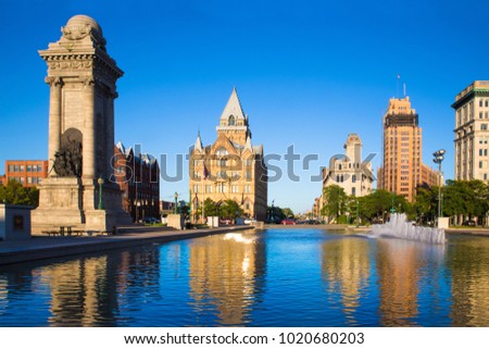 Downtown Syracuse New York with view of historic buildings and fountain at Clinton Square. Royalty-Free Stock Photo #1020680203