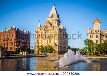 Downtown Syracuse New York with view of historic buildings and fountain at Clinton Square. Royalty-Free Stock Photo #1020680206