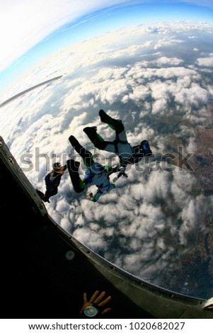 Skydivers exiting plane