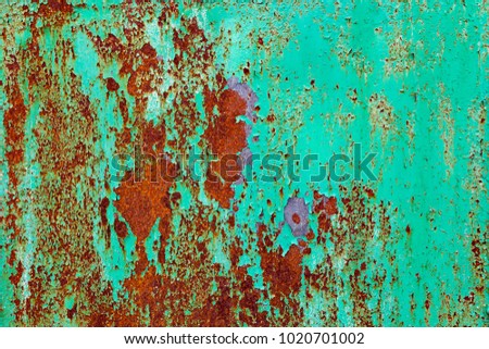 Old metal green wall with streaks of rust for creativity, textures and backgrounds.