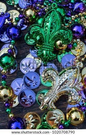 mardi gras necklaces and beads with green, gold, and purple Fleur De Le coins