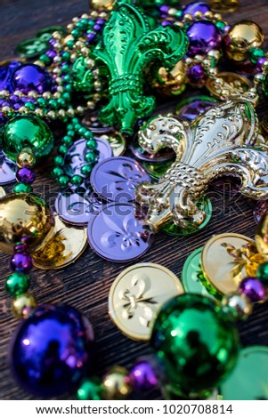 mardi gras necklaces and beads with green, gold, and purple Fleur De Le coins