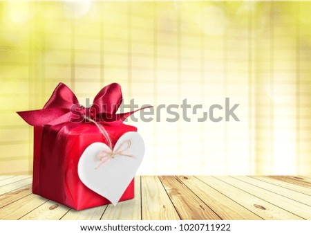 Gift box and heart on wood desk