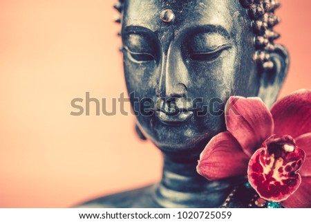 Buddha’s head and orchid flower