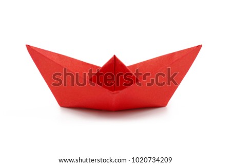 Red paper ship isolated on white background. Paper craft and origami. Close up. 