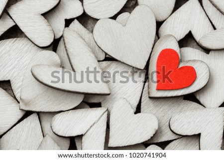 Vintage style of 2 red hearts with wooden hearts on a wooden background. Happy Valentine's Day concept.