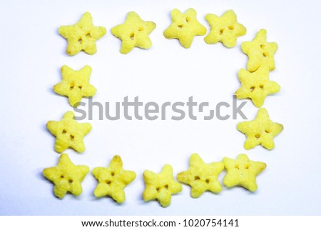 De focused Dry yellow fresh breakfast triangle cereal  in smile on white background. Close-up of a smile of triangle breakfast cereals.
