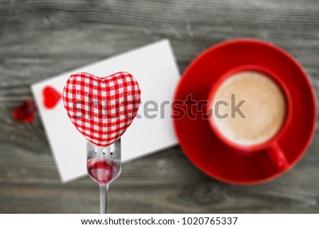Handmade heart on steel fork and coffee