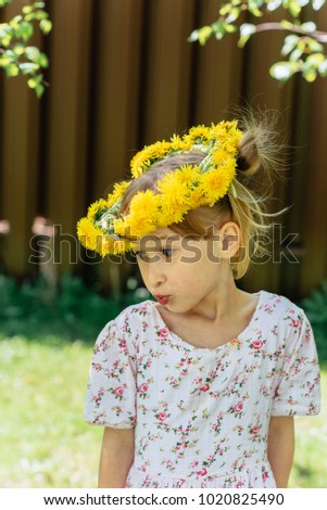 Girl, Life in summer.Spring in the forest. Girl and spring. A wreath of dandelions on the head of a little girl. Spring-springing. In the spring in the forest a little girl.