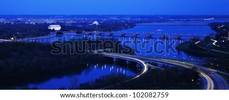 This is an aerial view of Washington, DC. The Potomac River runs through the center with the Key Bridge at right .