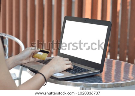 Girl hands holding credit card and using laptop. Online shopping concept.