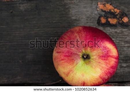 Red apple with water drops on old grunge background.