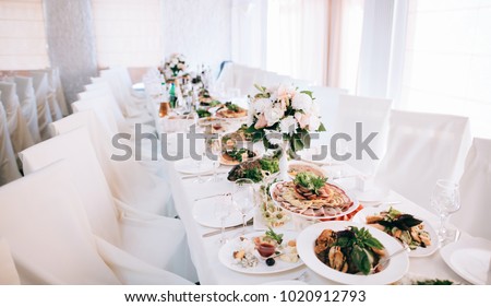 Catering services and table decoration. glasses set and dish with food meal in the wedding restaurant Royalty-Free Stock Photo #1020912793