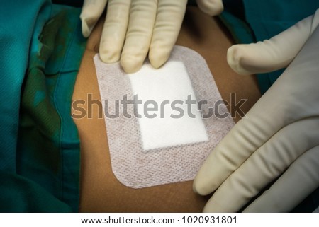 Op-site dressing at laparotomy wound applied immediately to the patient after surgery. Royalty-Free Stock Photo #1020931801