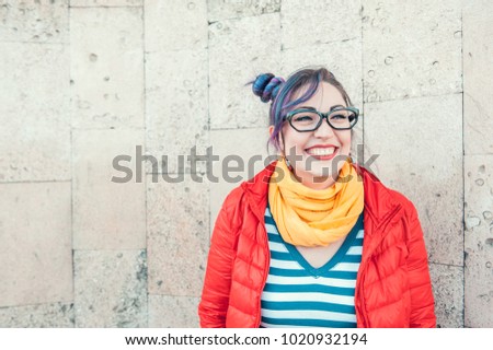 Happy beautiful fashion hipster woman with colorful hair laughing outdoor