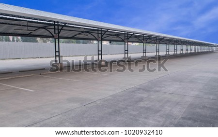 perspective of outdoor empty parking lot with steel tube structure and metal sheet roof, number sign of lot each