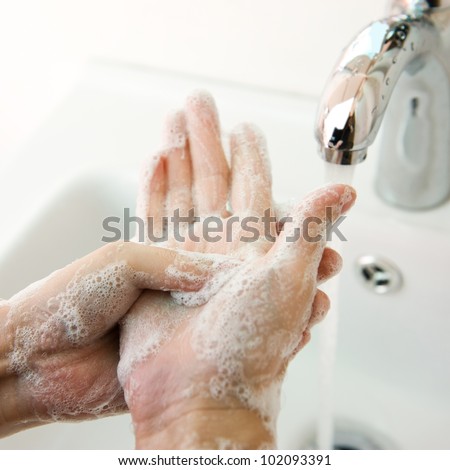 Washing of hands with soap under running water. Royalty-Free Stock Photo #102093391