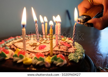 lighting candles on birthday cake