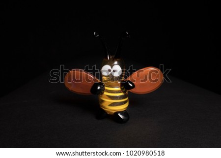 a glass bee, a figurine of a bee,