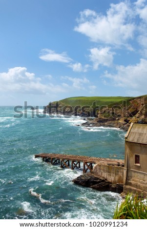 Early summer afternoon sunshine after a storm on the old lifeboat station at Lizard Point in the Lizard Peninsula, Cornwall, UK