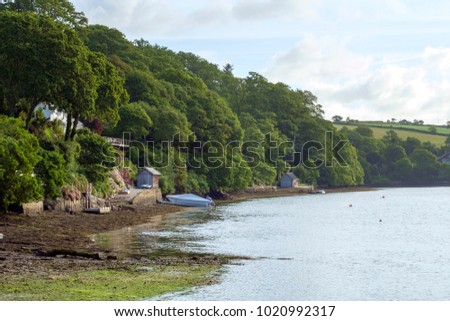 Peaceful early summer morning on picturesque boat moorings in the Helford Estuary at old fashioned Port Navas, Cornwall, UK