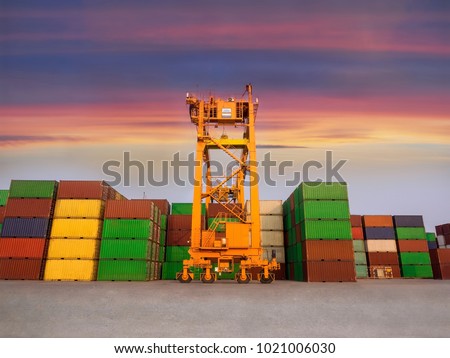 The RTG(Rubber Tried Gantry Cranes) is moving full loaded containers at industrial port and container yard   for prepare delivery to customers. Royalty-Free Stock Photo #1021006030