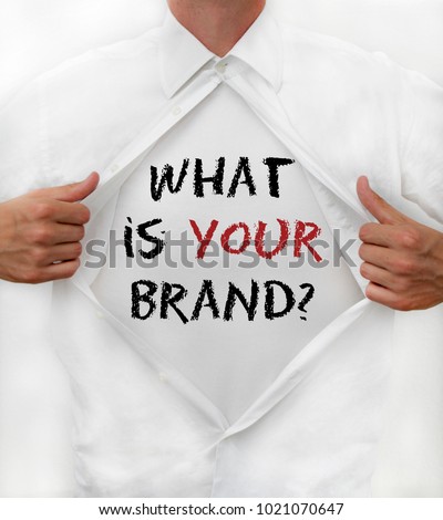 Man opens shirt and reveals the words What is YOUR brand? Royalty-Free Stock Photo #1021070647
