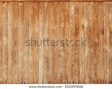Texture - a rustic old pediment made of vertical, unpainted planks of warm yellow color. Wallpaper.                       